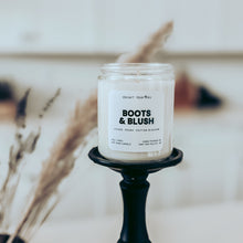 Load image into Gallery viewer, Boots and Blush candle on a black candlestick