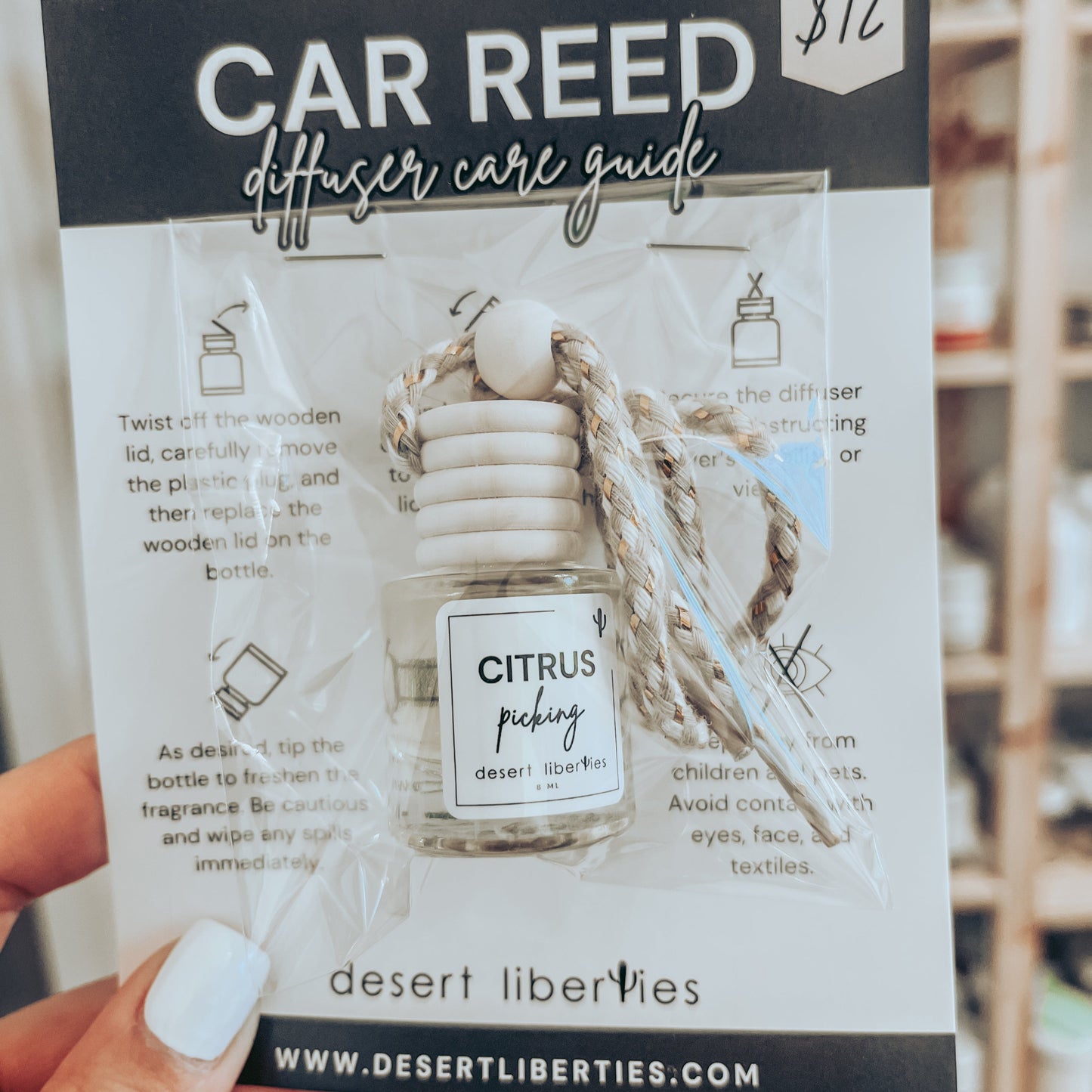Citrus picking car diffuser packaged in a cello bag on a care card