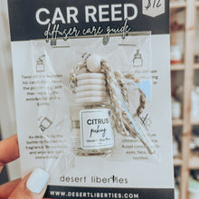 Load image into Gallery viewer, Citrus picking car diffuser packaged in a cello bag on a care card