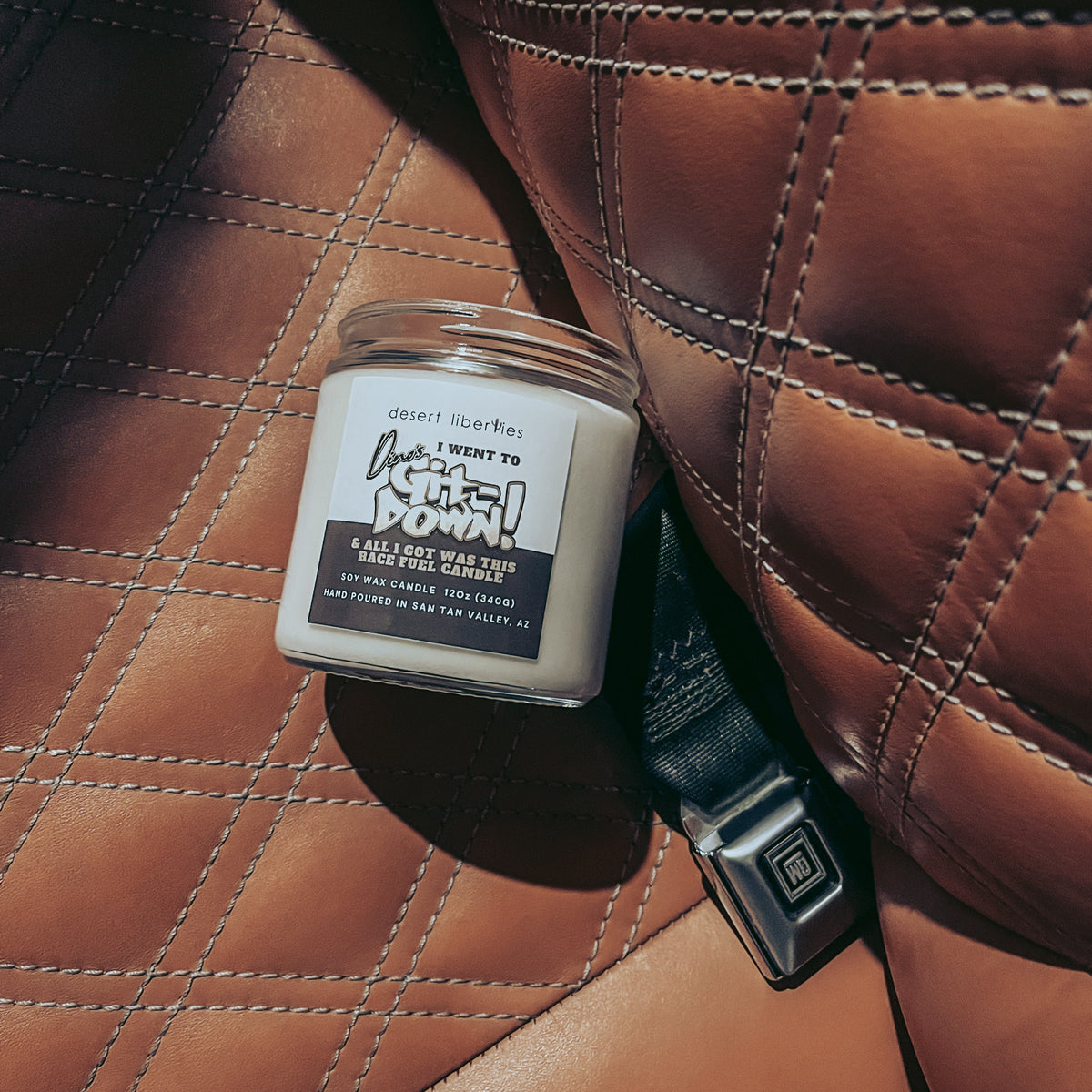 Dino's Git Down inspired candle on a leather truck bench.