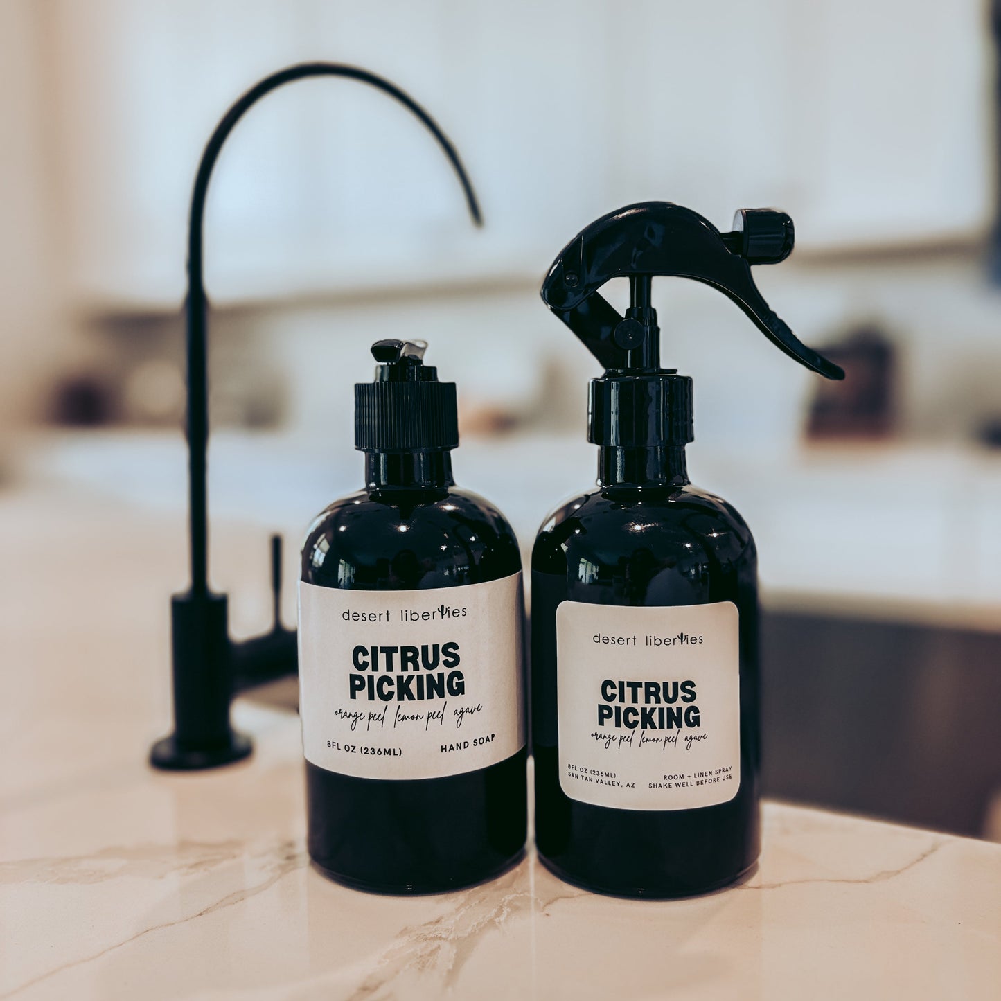 Two bottles labeled 'Citrus Picking' on a kitchen counter.