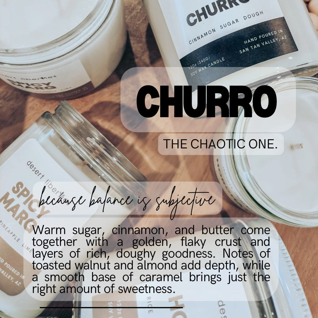 Candles labeled 'Churro' and 'Spicy Marg' with descriptive text on a wooden surface.