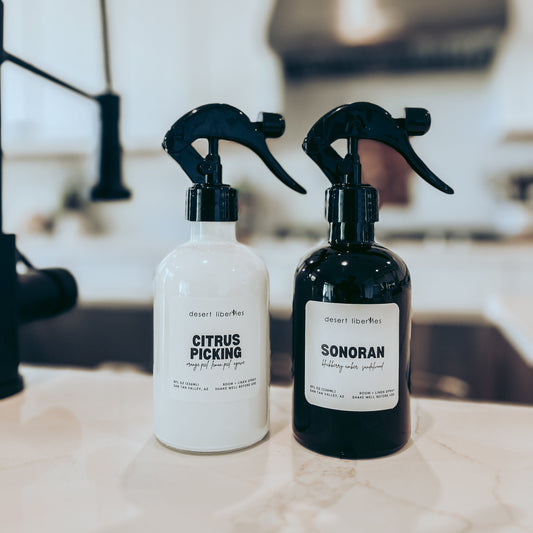 Two spray bottles labeled 'Citrus Picking' and 'Sonoran' on a kitchen counter.