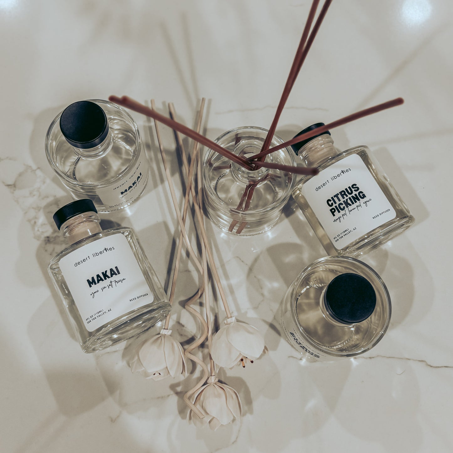 Set of reed diffusers with labels on a light background