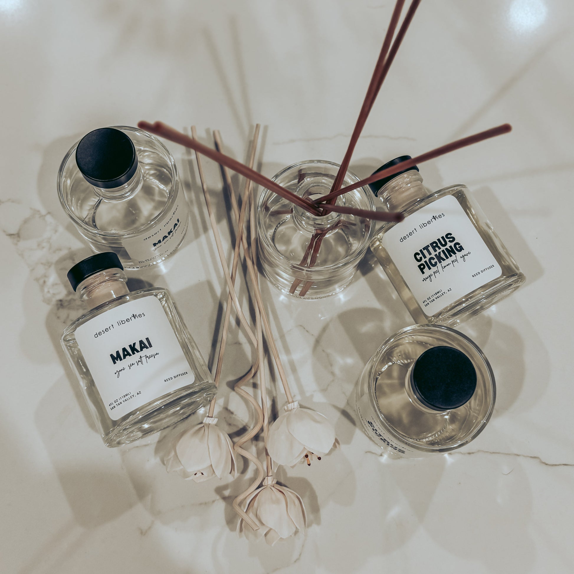 Set of reed diffusers with labels on a light background