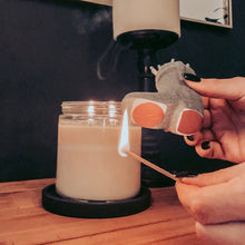 Load image into Gallery viewer, Hands holding a lit match with a candle lit
