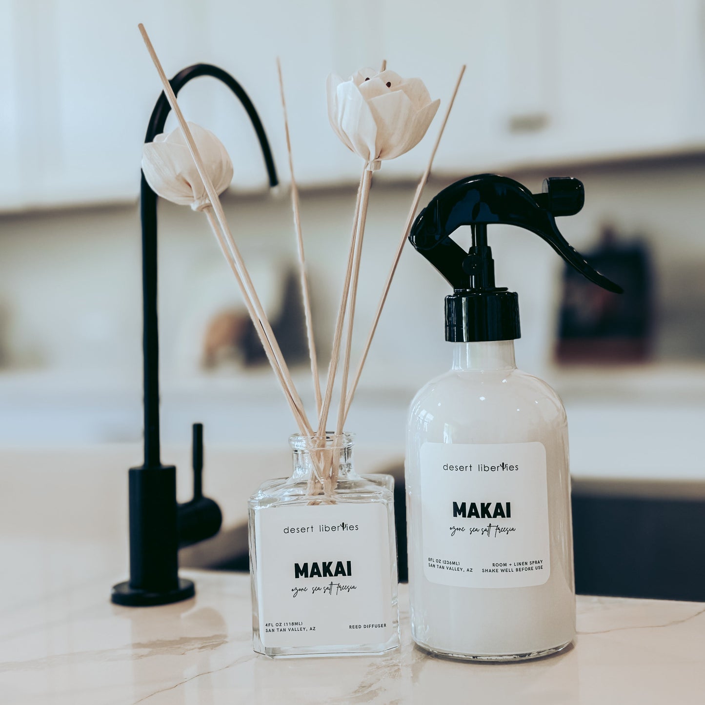 Two Makai products on a kitchen counter with flowers in the background