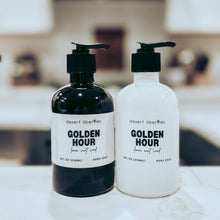 Load image into Gallery viewer, Two bottles of 'Golden Hour' hand soap on a surface with a blurred background
