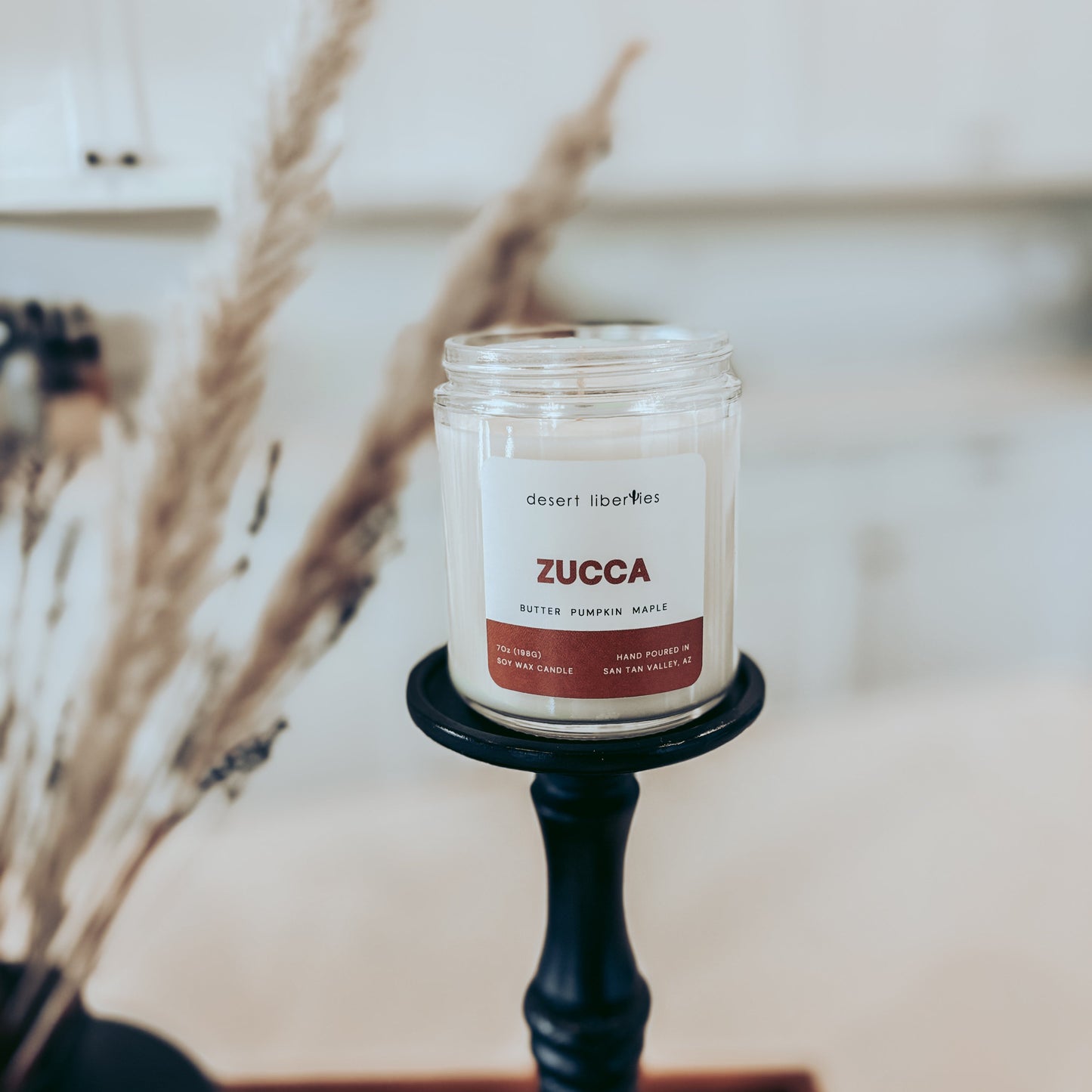 Zucca candle on a black holder with a blurred background