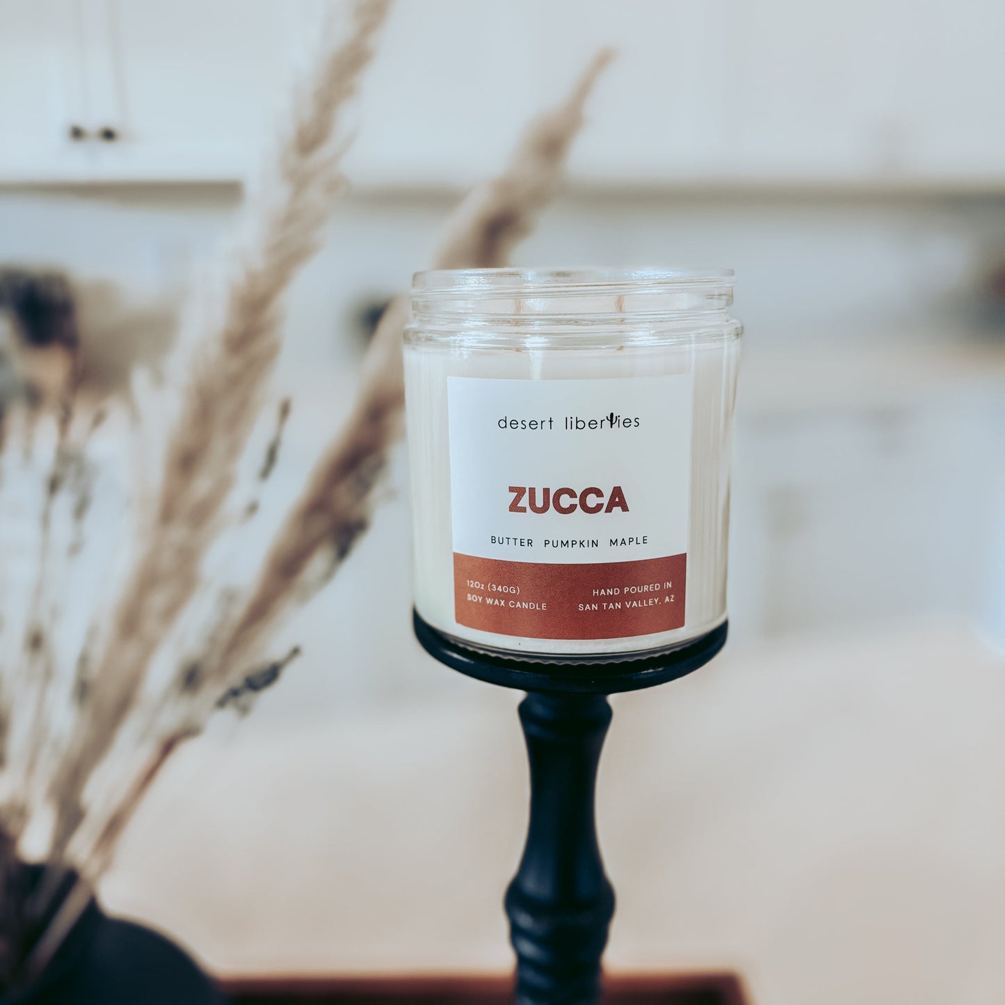 Zucca candle on a black holder with a blurred background