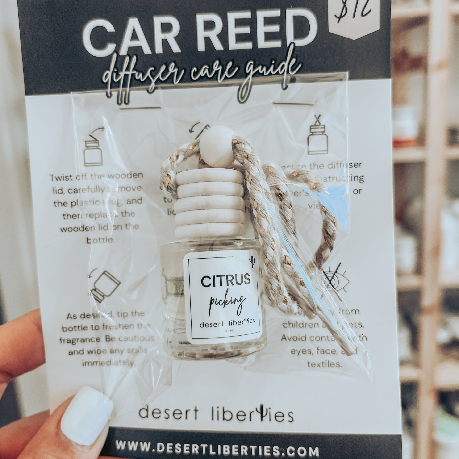 Citrus picking car diffuser packaged in a cello bag on a care card