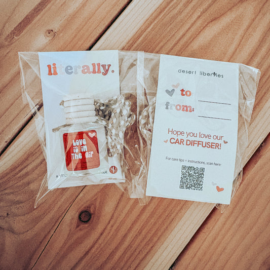 Car diffuser packaging with a card on a wooden surface