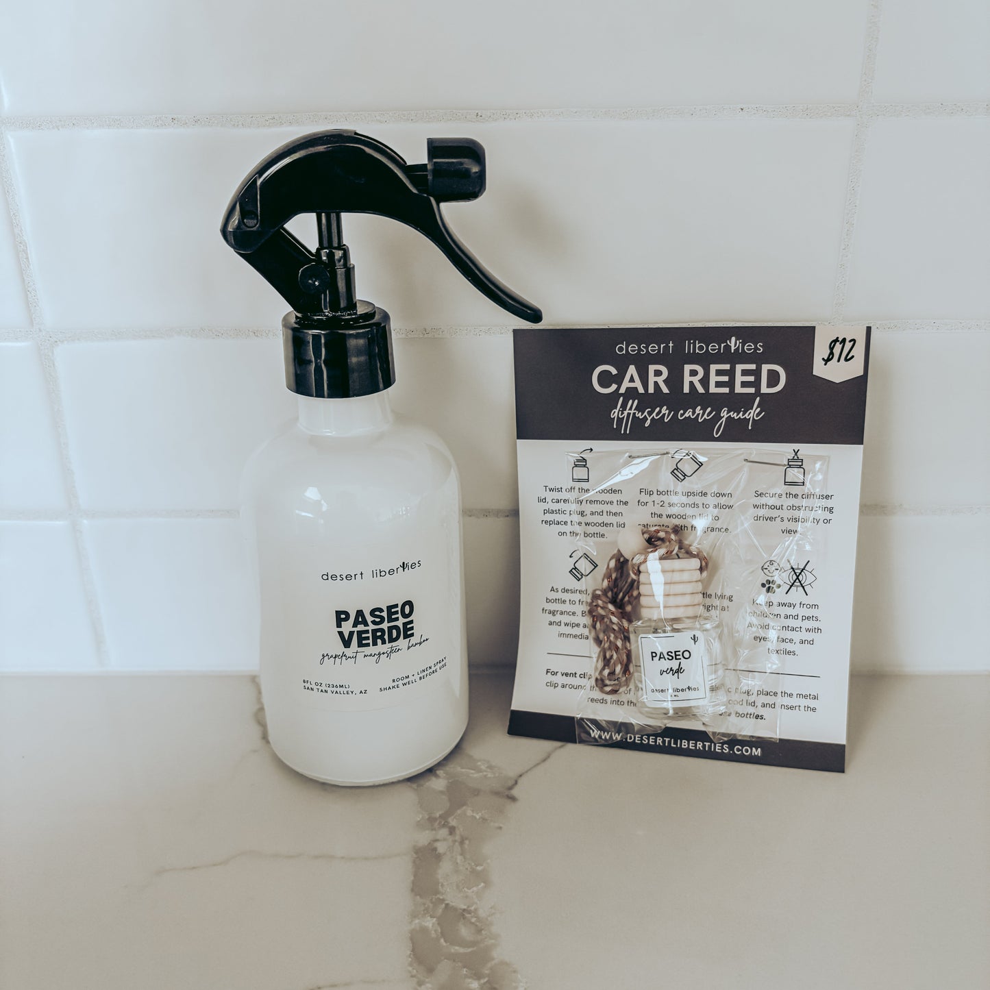 Spray bottle labeled 'Paseo Verde' next to a car care guide on a tiled surface.
