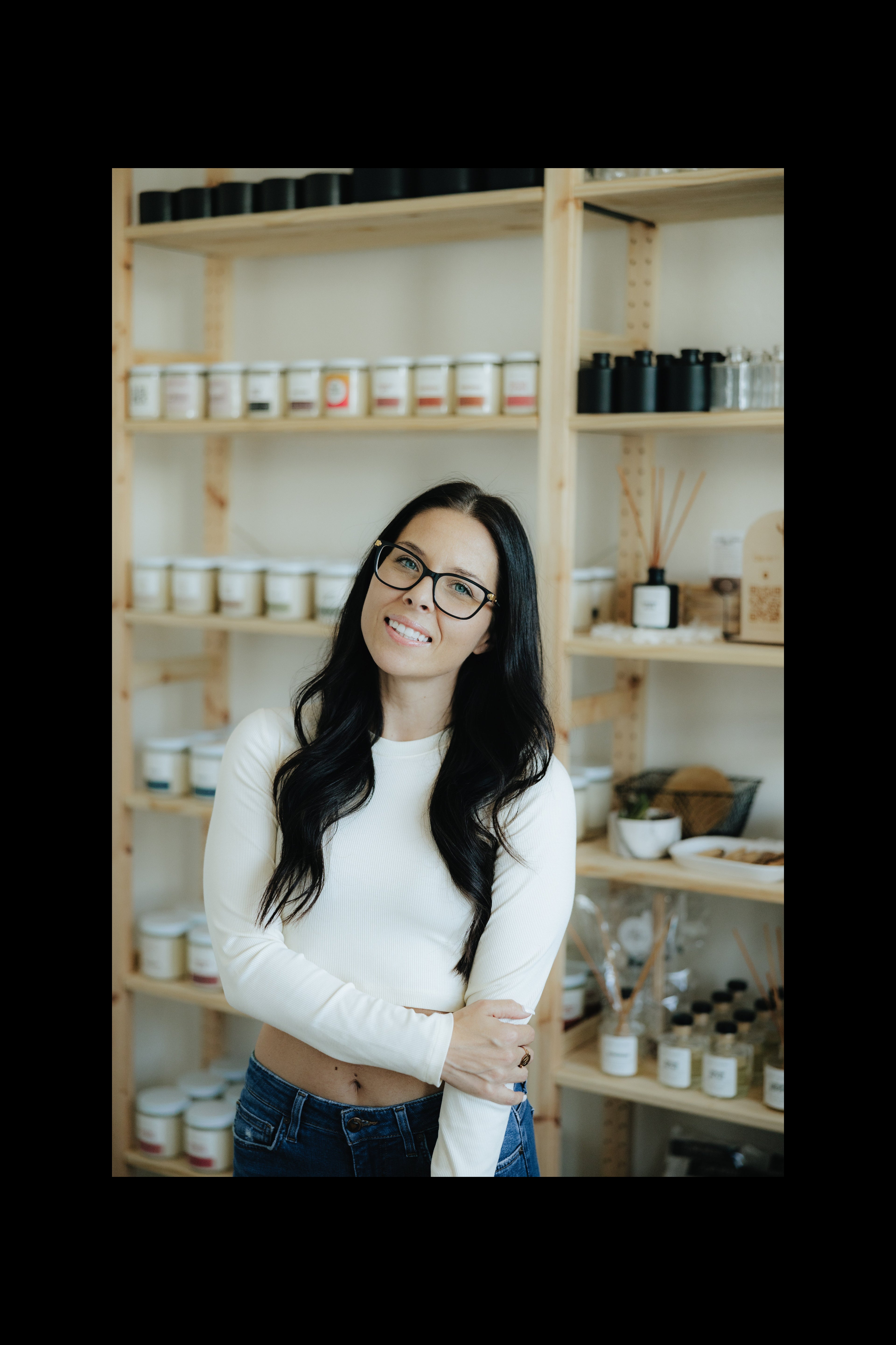 Woman standing in a store with shelves filled with products
